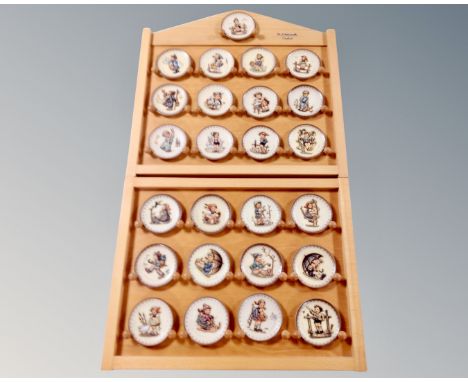 A German Hummell Goebel display stand containing twenty five plates 
