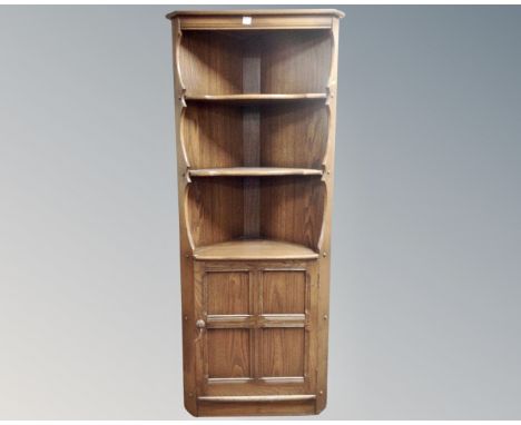 An Ercol stained elm corner cabinet.