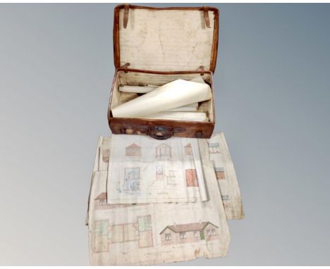 A vintage leather luggage case containing rolled architectural plans 