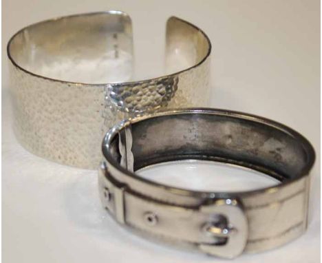 TWO SILVER BANGLES
one a Victorian buckle motif bangle, the other a later textured design bangle, 102.1g, both in god conditi