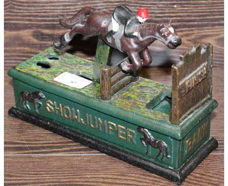 VINTAGE CAST IRON "SHOWJUMPER" MONEY BANK
modelled as a horse and jockey jumping a fence, 22cm long