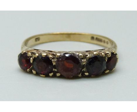 A 9ct gold and five stone garnet ring, 2.1g, J, (some claws a/f) 