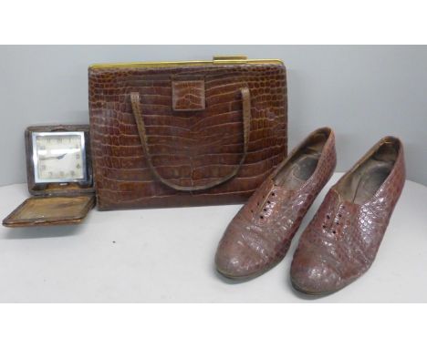 An Asprey crocodile skin handbag, a pair of vintage shoes and a travel clock 
