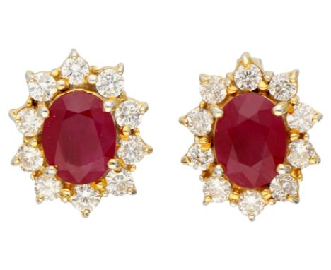 18K Yellow gold entourage ear studs set with 2.62 ct. natural ruby and diamond. Set with two oval faceted natural rubies (tre