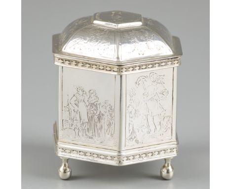 A silver marriage box. Hexagonal reproduction model of a 17th century wedding box from Friesland. The 6 sides each have an im