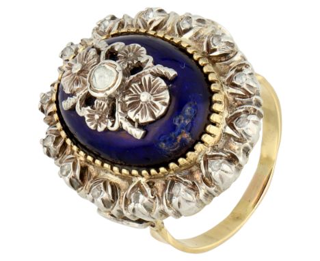 Gold / silver blue enamel entourage ring with diamond. An oval dome of blue enamel (damaged) set with a silver floral appliqu