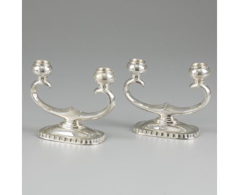 2-piece set of candlesticks silver. Set of two 2-light candlesticks, stylized design and with filled foot. Belgium / Germany,