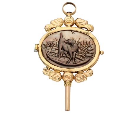 14K. Yellow gold watch key with hunting scene on Tahiti shell. Yellow gold watch key with carved representation of a hunting 