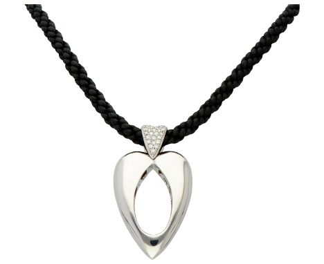 Piaget 18K white gold "Open Heart" pendant set with diamond on cord. The letters of Piaget are cut out on the inside of the p