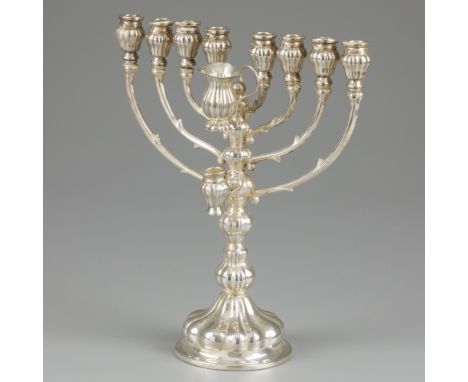 Hanukkah candlestick silver. A model with 8 + 1 holders and a holder with a pouring jug. With fluted details. The foot is fil