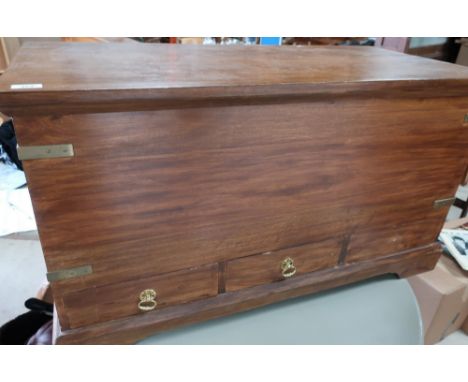 Hardwood rectangular blanket type box with hinged top, twin brass carrying handles and corner mounts with three drawers to th