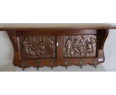 Dutch style oak wall shelf and coat rack with two embossed copper panels of tavern interior scenes (width 92cm) 