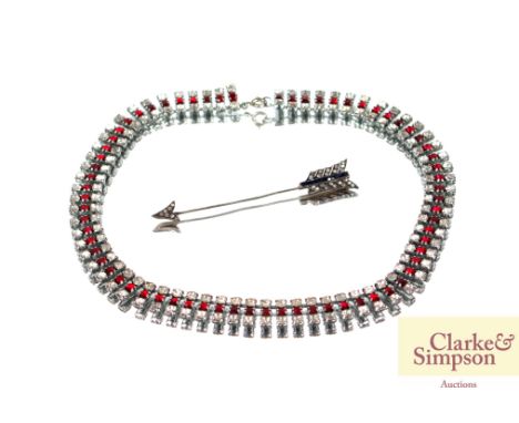 A costume necklace set red and white stones; and an arrow pin
