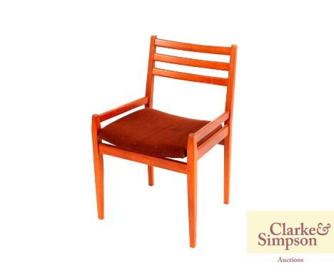 A circular teak extending dining table, raised on rounded tapering supports with folding extra leaf; and four similar ladder 
