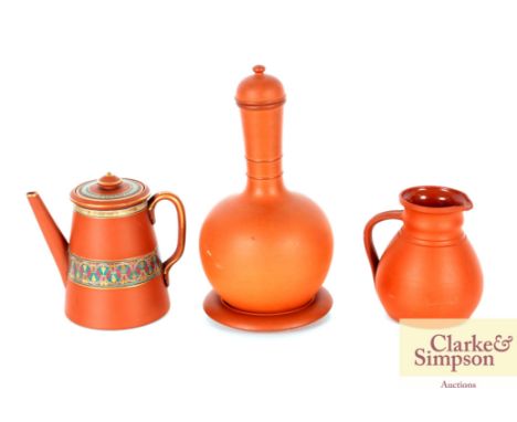 Attributed to Dr Christopher Dresser, an unusual large terracotta coffee pot, a Wedgwood ewer with "R.D." lozenge for 1873; a