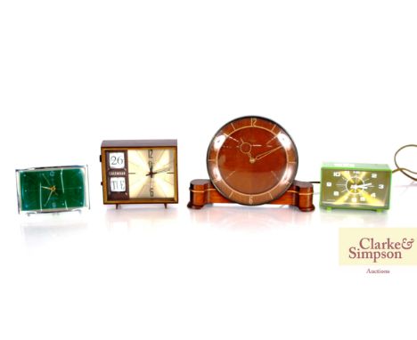 A Smiths electric mantel clock; a Japanese made alarm calendar clock; a Westclox bell alarm clock and a Chinese made alarm cl