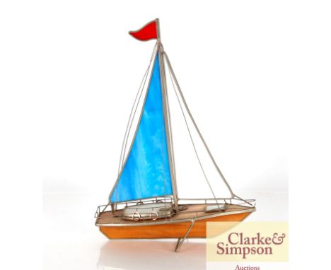 A model of a sailing yacht with Tiffany style glass panels to the sails and hull