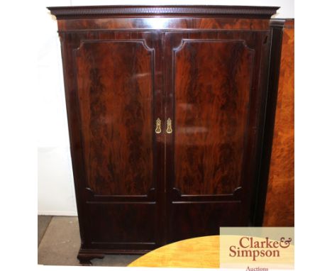 A mahogany compactum type wardrobe by Waring &amp; Gillow Ltd, Lancaster with hanging comportment and an interior fitment of 