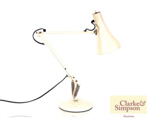 A cream angle poise type lamp