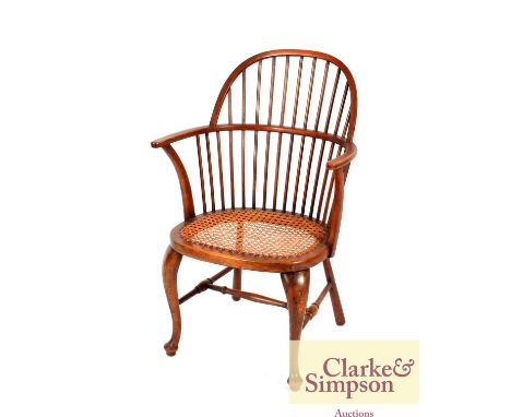 A Windsor style stick back chair having cane seat 