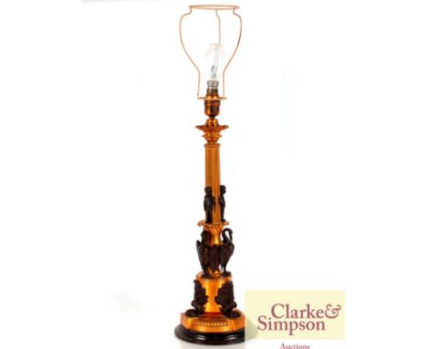 A gilded and bronzed Corinthian column table lamp having raised figural and phoenix decoration, complete with shade, 74cm hig