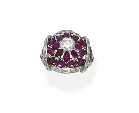 A ruby and diamond ringOf openwork bombé form, centrally set with a brilliant-cut diamond, within an openwork surround of mar