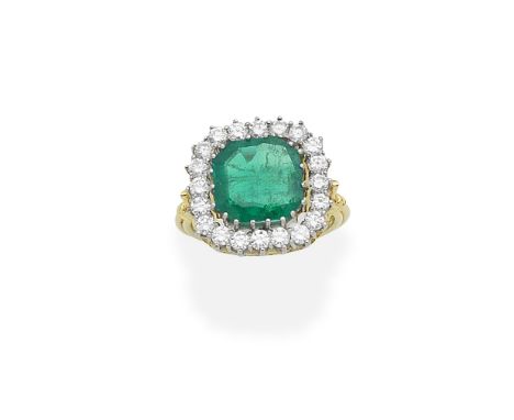 An emerald and diamond cluster ringThe octagonal step-cut emerald weighing 4.15 carats, within a brilliant-cut diamond surrou