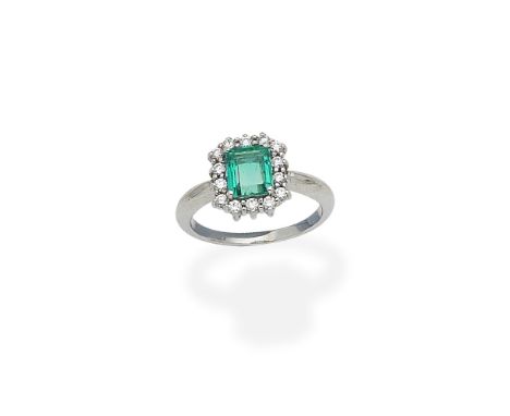 An emerald and diamond cluster ringThe step-cut emerald within a surround of brilliant-cut diamonds, ring size approx. L½Foot