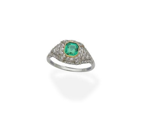 An emerald and diamond ringThe octagonal step-cut emerald within a pierced mount of millegrain-set single-cut diamonds, diamo