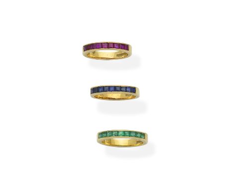 Three gem-set half-eternity rings, 1982Each set to the front with step-cut emeralds, rubies or sapphires, mounted in 18 carat