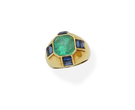 An emerald and sapphire ringThe octagonal step-cut emerald collet-set within a bombé mount, accented by step-cut sapphires,  