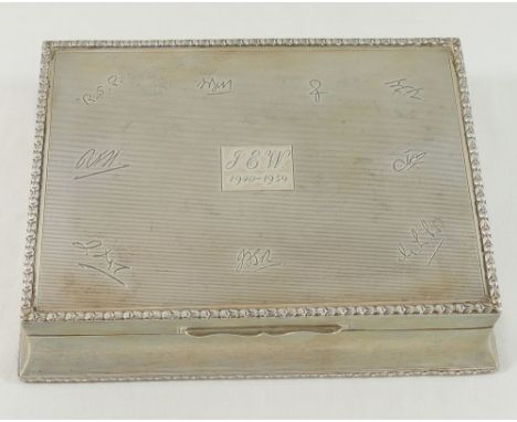 A large mid 20th century rectangular silver cigarette box, London 1957, with engine turned decoration, inscriptions and woode