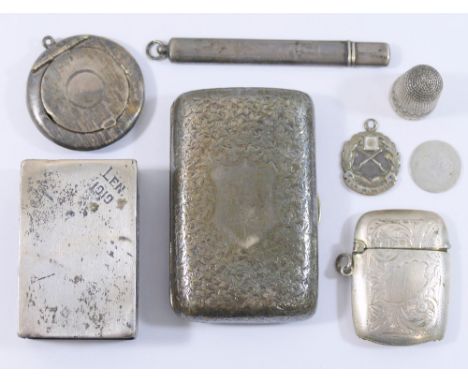 A collection of small silver items comprised of a matchbox holder, thimble, cigarette case, vesta case, circular pill box, a 