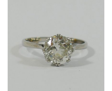 A early 20th century diamond single stone ring, the old cut stone approximately 2.10 carats, Si I, J-K, within coronet double