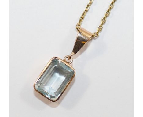 An aquamarine pendant, the emerald cut aquamarine in open back rub-over setting stamped '375', and chain stamped '585', 46cm 