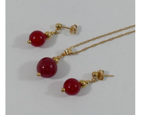A yellow metal mounted cultured pearl earring and pendant suite, stamped '14K', and chain stamped '375', and a similar red ha
