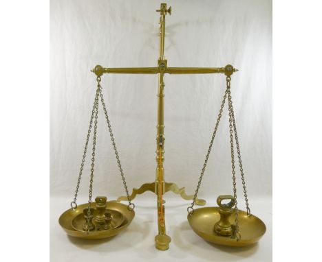 A set of brass apothecary scales, 56.5cm high, and a set of seven brass bell weights CONDITION REPORT: Please note - Descript