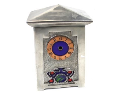 An Arts and Crafts mantle clock case. The metal case of tapered shape, with enamel dial and details, H23cm   Condition Report