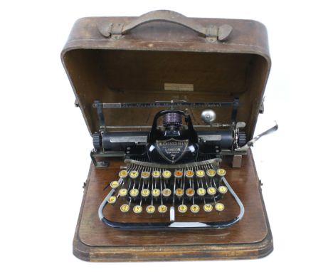 A Victorian Blickensderfer no. 7 portable manual typewriter. In its original wooden travelling case. With a QWERTY keyboard. 