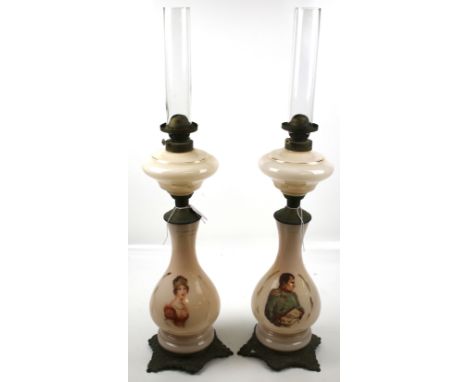 A pair of oil lamps. The glass stands printed with a portrait of Napoleon and a queen, mounted on metal stands, H56cm (exclud