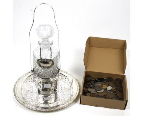 An assortment of silver plate, glassware and coins. Comprising a silver-plated round salver, a plated decanter stand and a cu