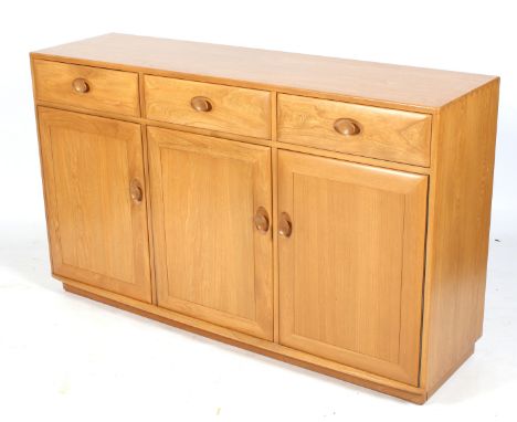 A mid-century Ercol sideboard. Three drawers above three doors. L155cm x D44cm x H93cm Condition Report: In an excellant cond