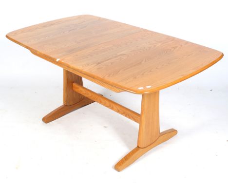 A mid-century Ercol extending dining table. With rounded corners, with twin pedestals united by a stretcher. Closed L152cm x 