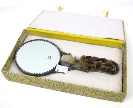 A Chinese ladies white metal hand mirror. Having a carved hardstone handle and relief decoration of a dragon to the mirror ba