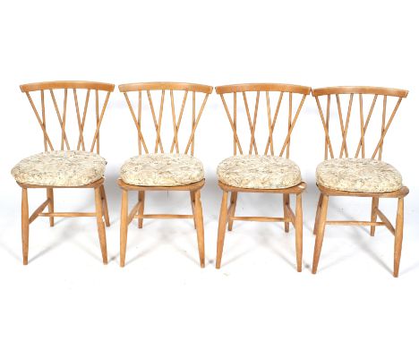 A set of four Ercol mid-century dining chairs. Stick back with flat back rest, turned supports united by stretchers. H78cm Co