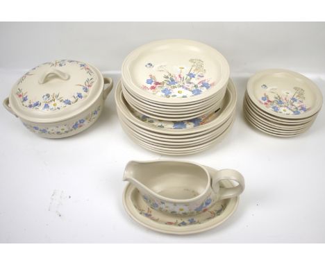 A Poole pottery dinner service. Comprising small, medium and large plates, a tureen and a sauce boat