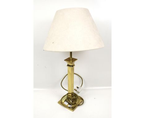 A contemporary table light. The brass stand on a circular base, H57cm (including the shade)