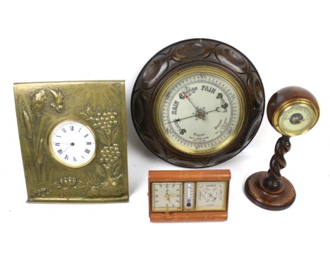 Two clocks and two oak cased barometers. Including a brasswork easel clock, a travel clock barometer, etc. Max. H24cm