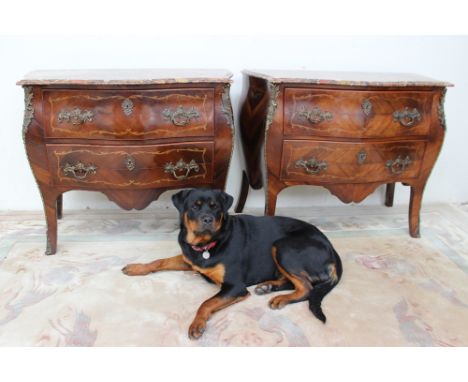 A pair of continental kingwood bombe commodes, the serpentine shaped marble top above two drawers on splayed bracket feet wit