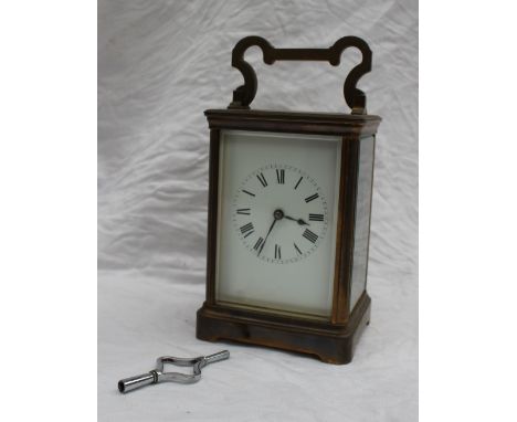 A brass carriage clock, with a lever platform escapement, an enamel dial with Roman numerals striking on a gong, 18cm high 
